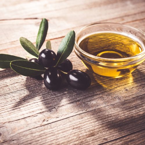 Olive oil with leaves and olives